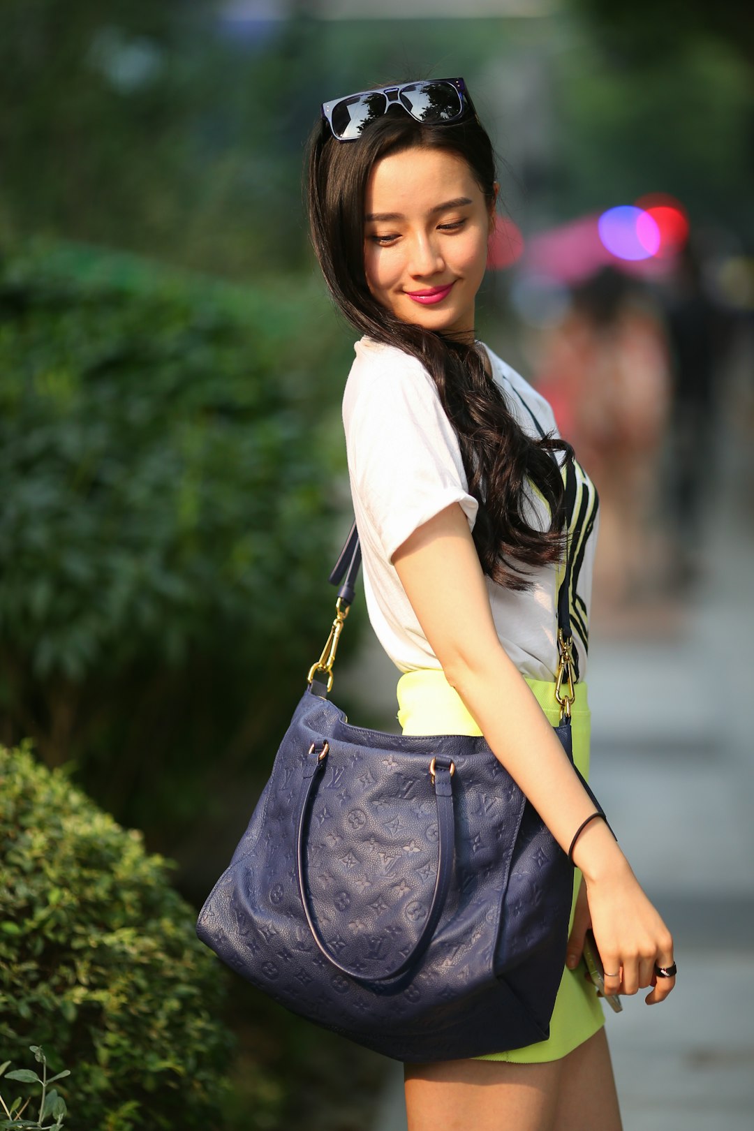 Woman carrying custom OEM manufactured leather sling bag — fashion brand OEM collaboration