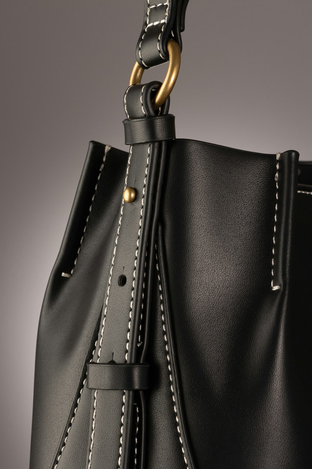 2026 women's handbag trends — black structured top handle bag with gold hardware