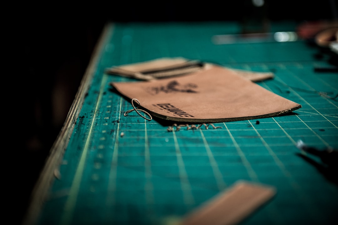 Genuine leather materials on cutting board — professional handbag material selection